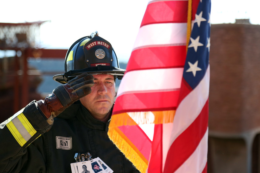 Tyler Hecox with West Metro Fire stands to salute the American Flag during the 9/11 Stair climb held at Red Rocks Sept. 11.